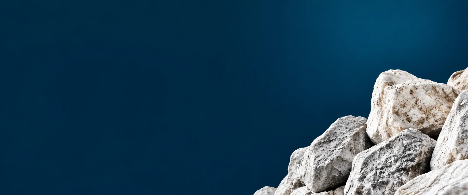 White mineral stones against a deep blue background