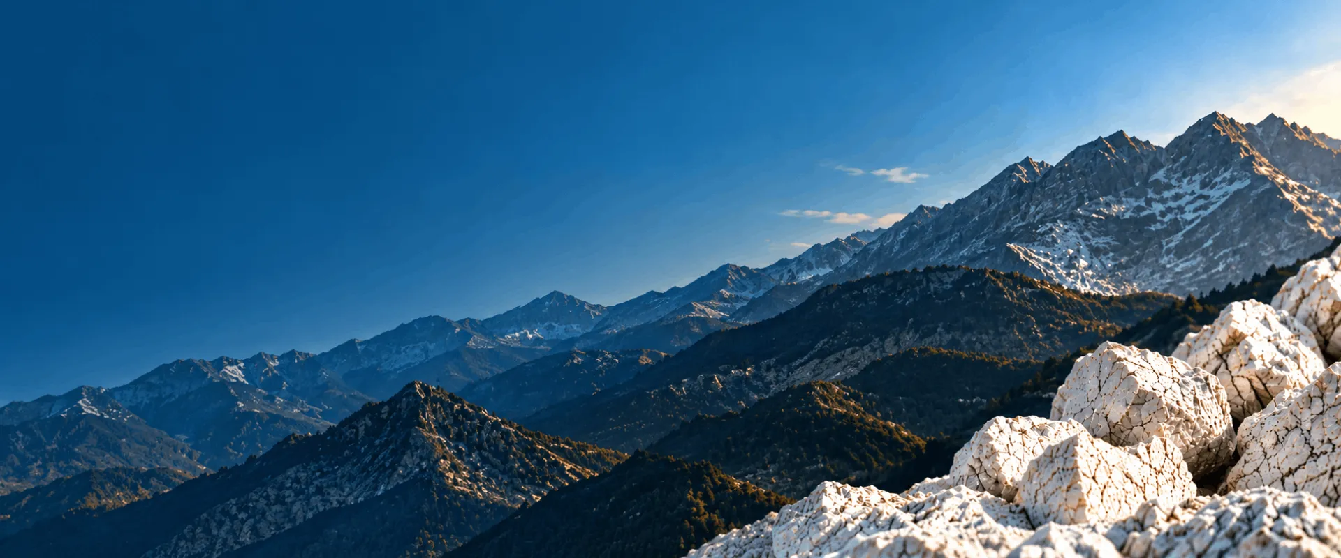 Mountain range with white mineral rock in the foreground