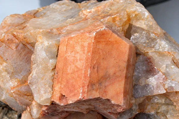 Raw feldspar mineral with pink and cream crystal faces